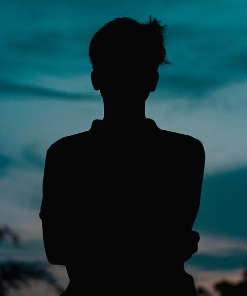 Silhouette of a person in a meditative state, looking calm.